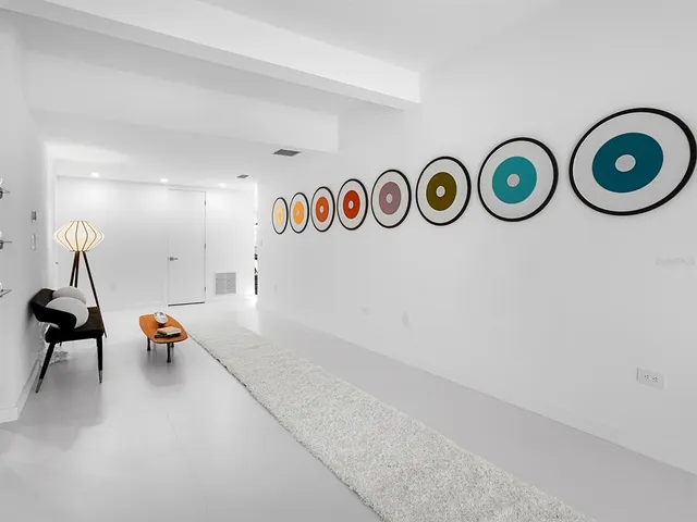 a bathroom with a sink and mirror with shower