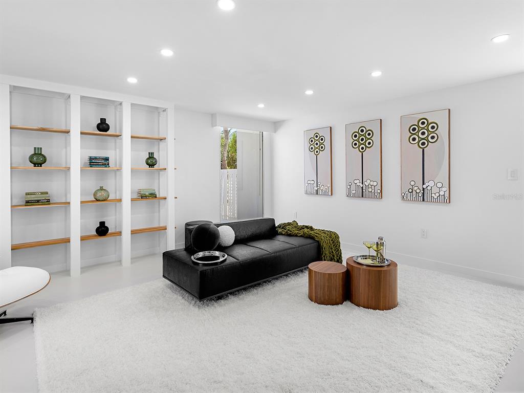 7647 Sanderling Road Sarasota, FL 34242 - Photo 13 of 75 a living room with furniture and a wooden floor