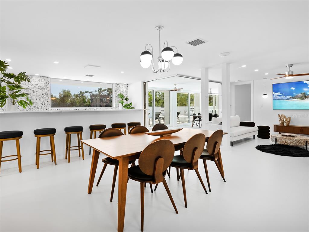 7647 Sanderling Road Sarasota, FL 34242 - Photo 16 of 75 a dinning table and chairs in a kitchen