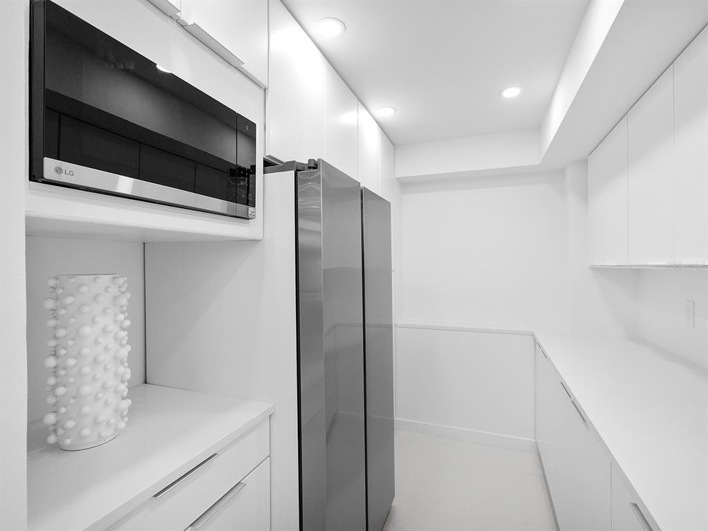 7647 Sanderling Road Sarasota, FL 34242 - Photo 25 of 75 a bathroom with a shower and a microwave