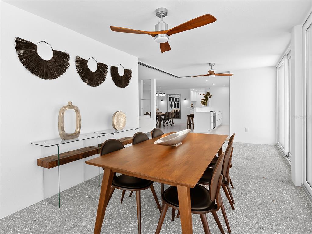7647 Sanderling Road Sarasota, FL 34242 - Photo 29 of 75 a view of a dining room with furniture and a chandelier