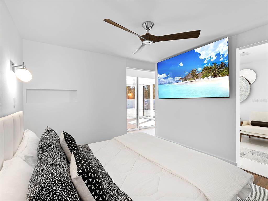 7647 Sanderling Road Sarasota, FL 34242 - Photo 31 of 75 a bedroom with a bed and a painting on the wall