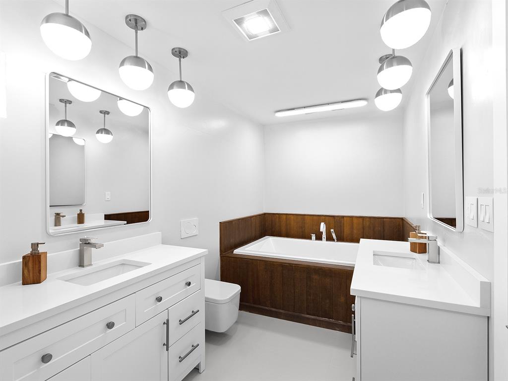 7647 Sanderling Road Sarasota, FL 34242 - Photo 33 of 75 a bathroom with a sink a toilet and a mirror