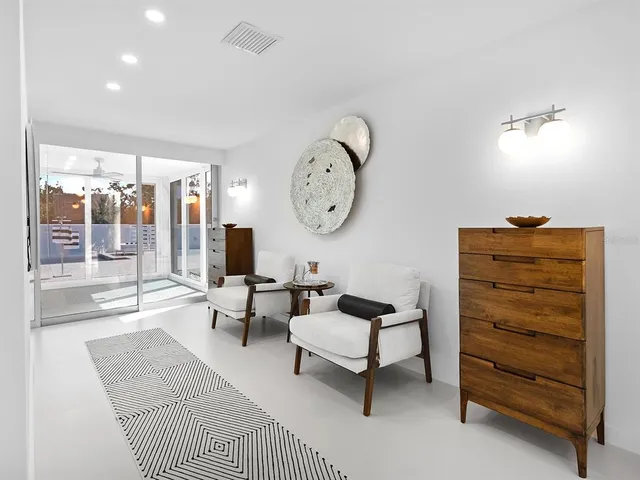 a spacious bedroom with a bed and a couch