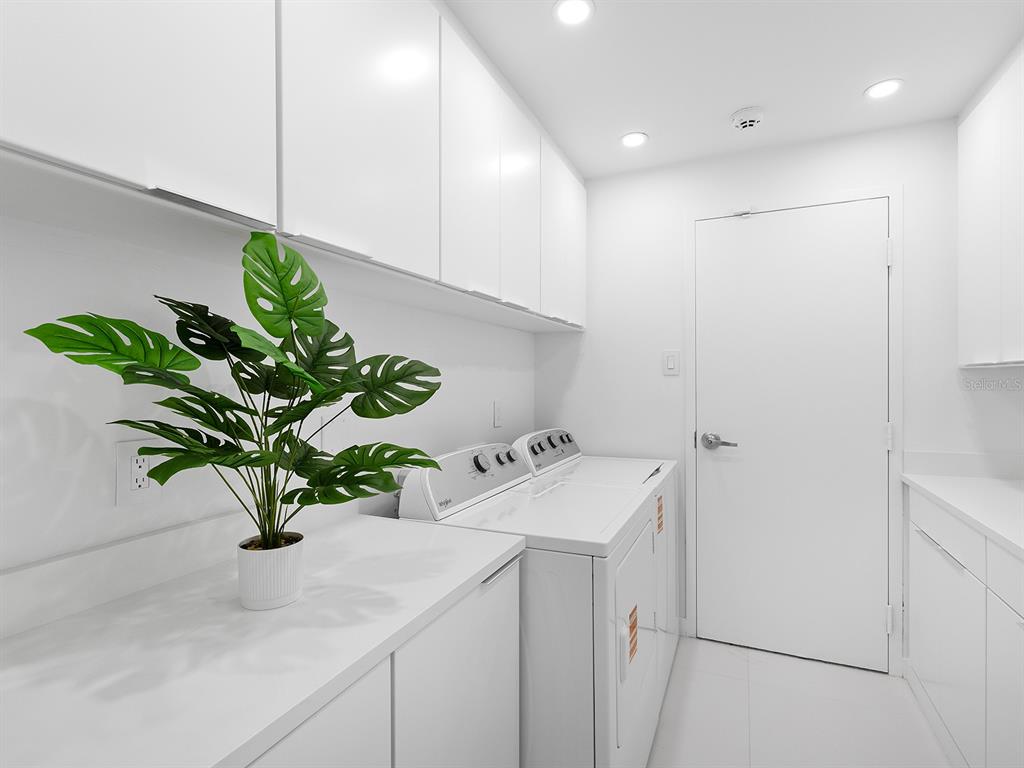 7647 Sanderling Road Sarasota, FL 34242 - Photo 36 of 75 a bathroom with a sink a vanity and a potted plant