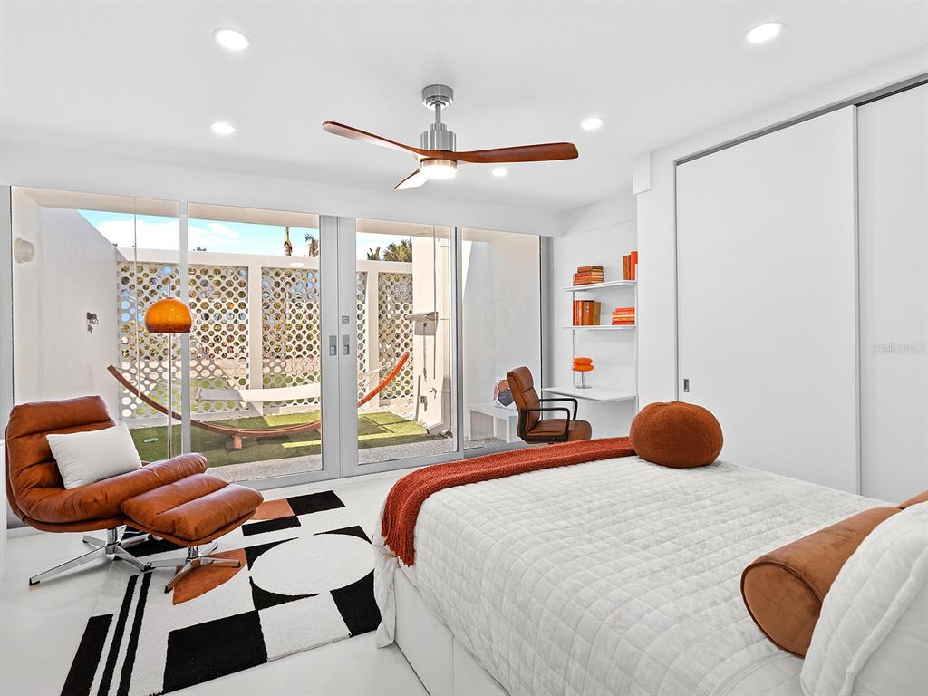 7647 Sanderling Road Sarasota, FL 34242 - Photo 37 of 75 a bedroom with a bed and window