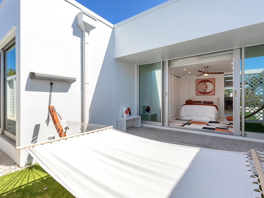 7647 Sanderling Road Sarasota, FL 34242 - Photo 39 of 75 a bedroom with a bed and ceiling fan