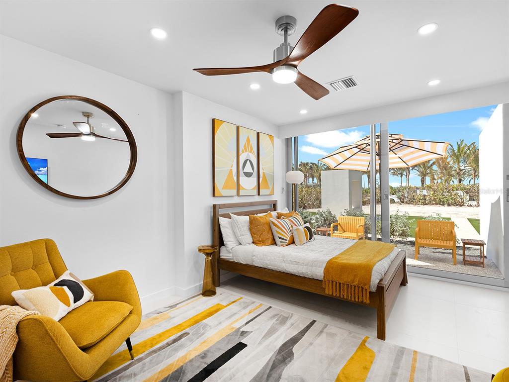 7647 Sanderling Road Sarasota, FL 34242 - Photo 40 of 75 a bedroom with furniture and a large window