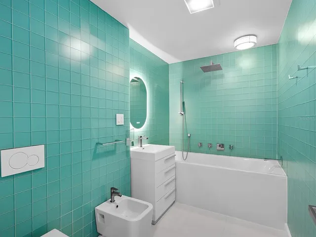 an aerial view of a house with a garden and lake view