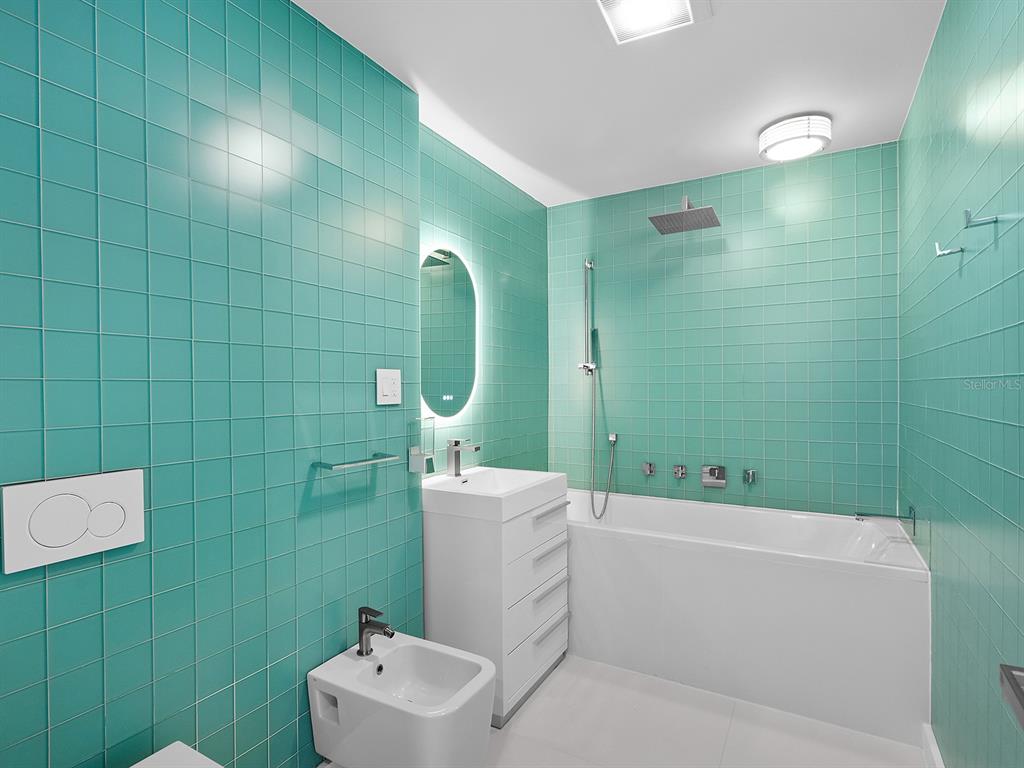 7647 Sanderling Road Sarasota, FL 34242 - Photo 43 of 75 a bathroom with a sink toilet and tub