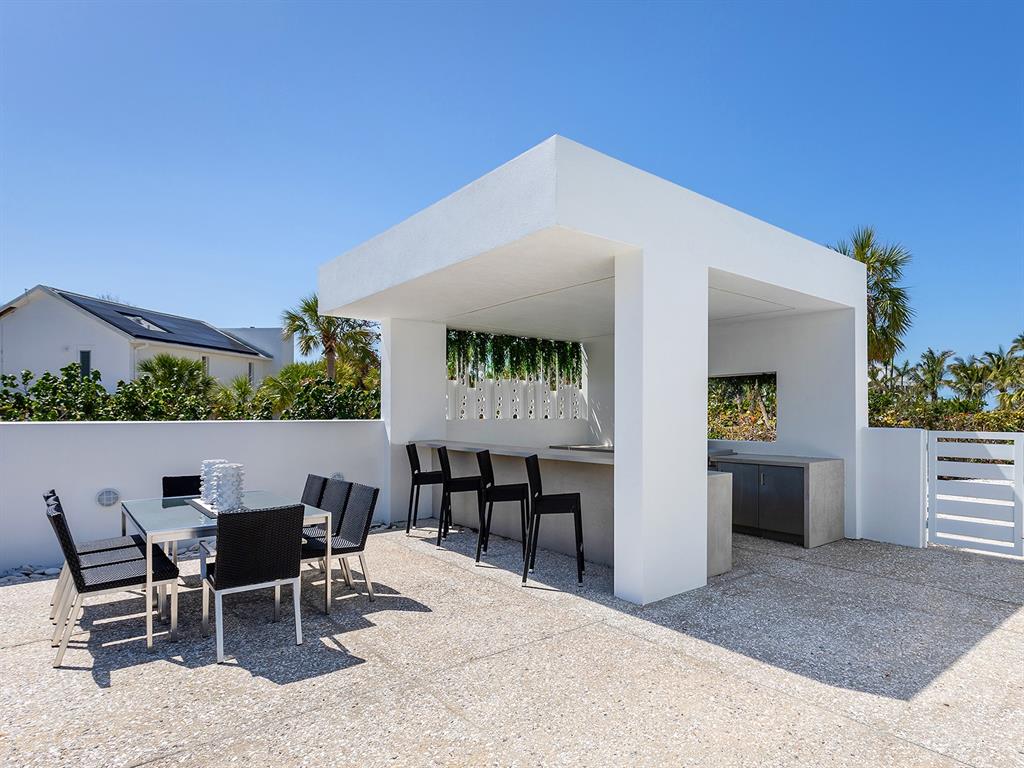 7647 Sanderling Road Sarasota, FL 34242 - Photo 44 of 75 a view of a dinning table and chairs in the patio