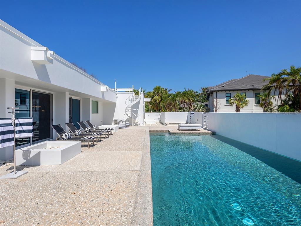 7647 Sanderling Road Sarasota, FL 34242 - Photo 49 of 75 a view of a house with backyard and sitting area
