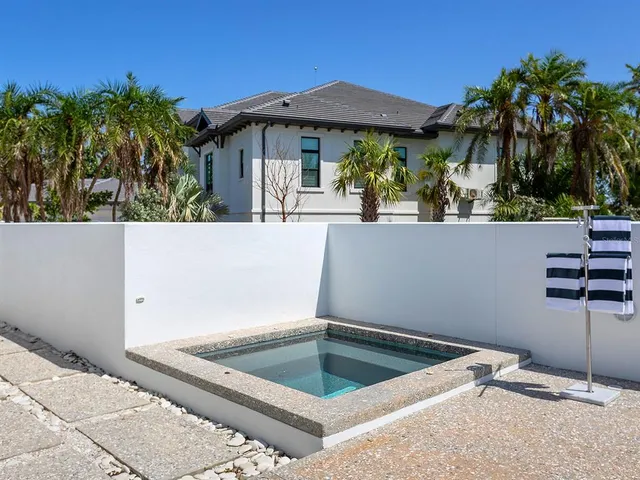 a view of a patio with swimming pool and sitting area