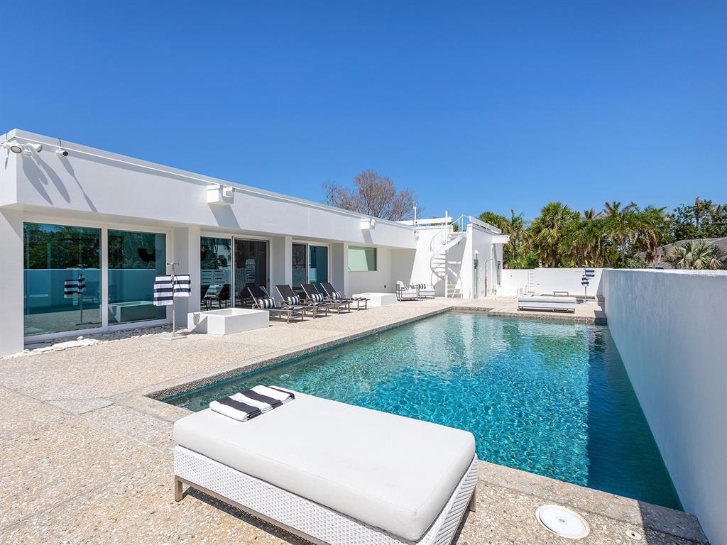 7647 Sanderling Road Sarasota, FL 34242 - Photo 52 of 75 a swimming pool with outdoor seating and yard