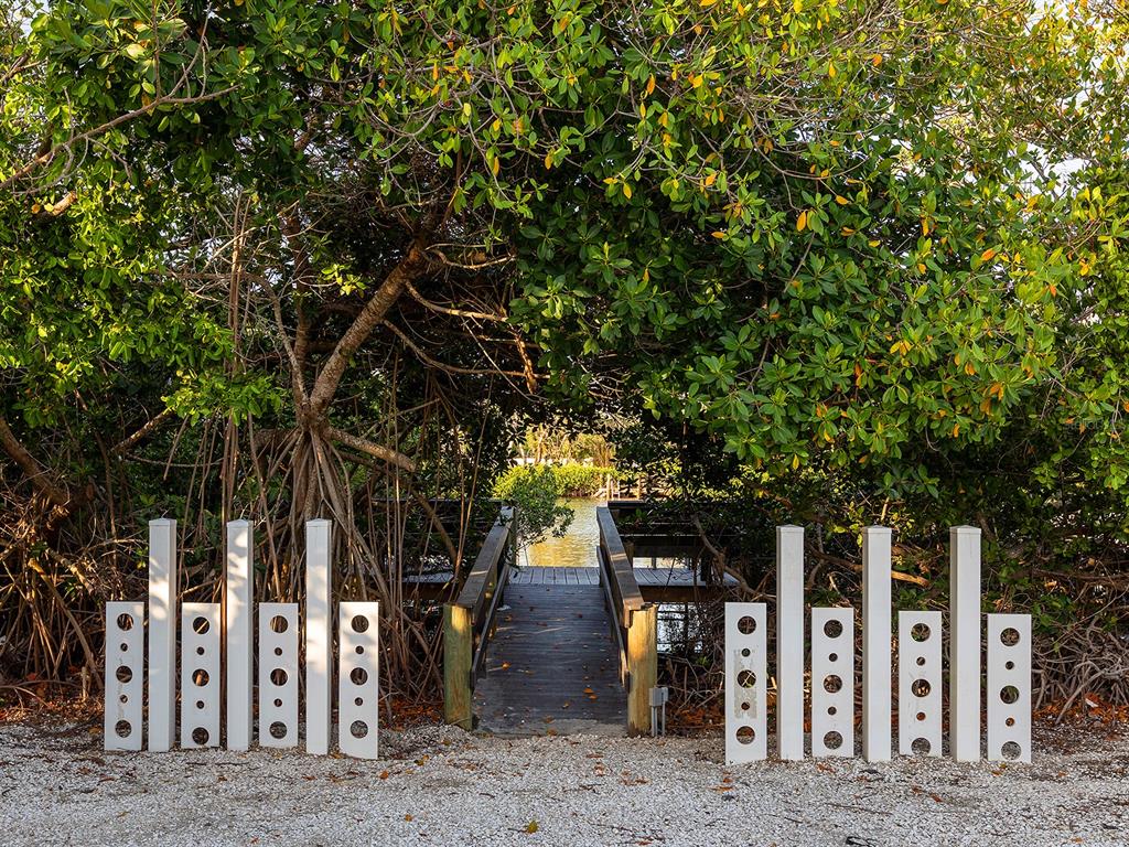 7647 Sanderling Road Sarasota, FL 34242 - Photo 58 of 75 a front view of a house with trees