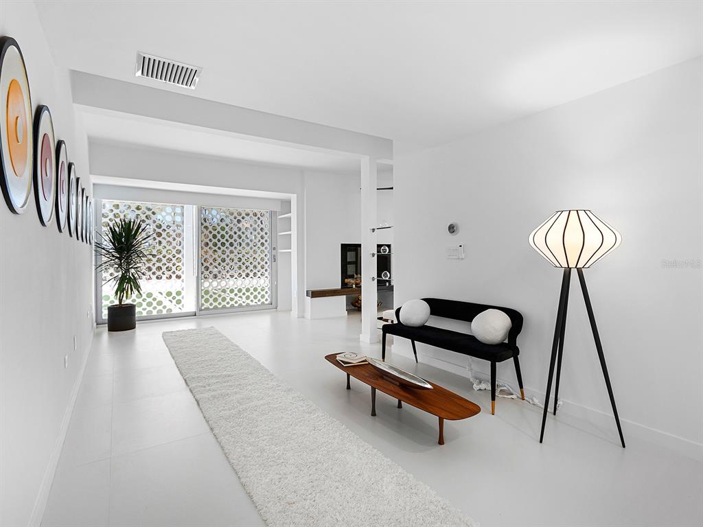 7647 Sanderling Road Sarasota, FL 34242 - Photo 10 of 75 a living room with furniture and a window