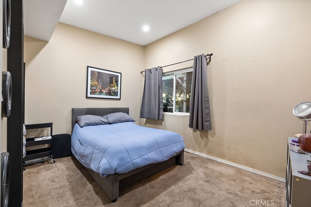 11633 Rincon Avenue Sylmar, CA 91342 - Photo 12 of 16 a bedroom with a bed and a window