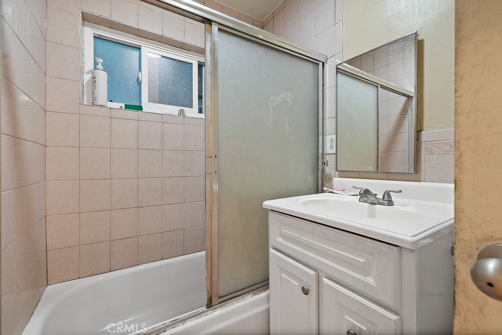 11633 Rincon Avenue Sylmar, CA 91342 - Photo 14 of 16 a bathroom with a sink and a mirror