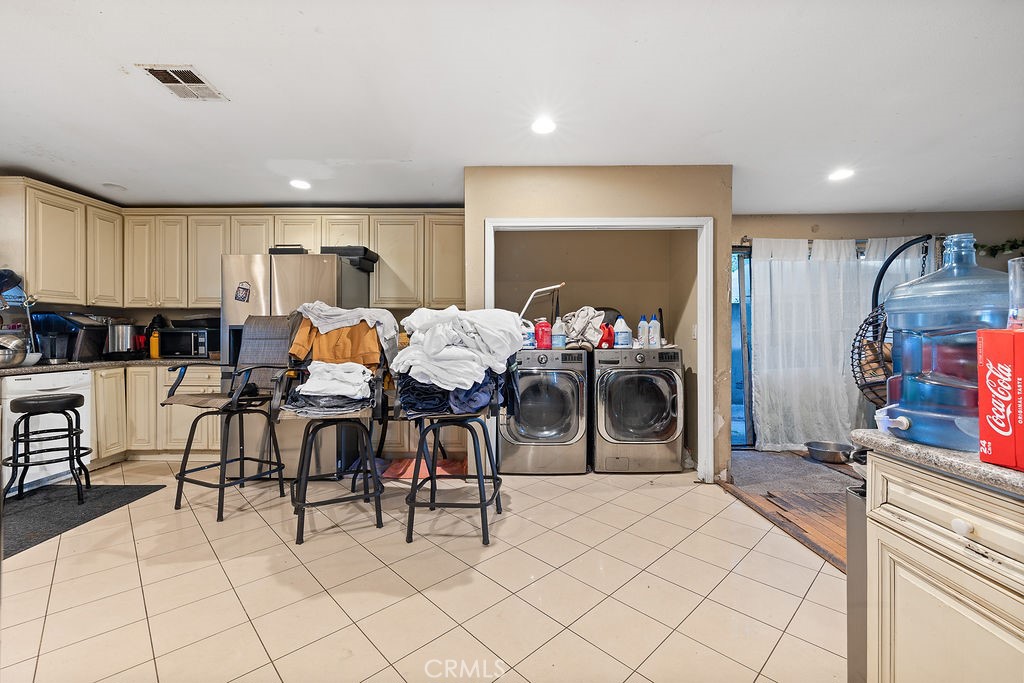 11633 Rincon Avenue Sylmar, CA 91342 - Photo 6 of 16 a living room with furniture a dining table and a fireplace