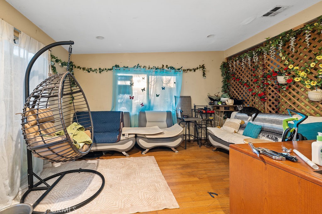 11633 Rincon Avenue Sylmar, CA 91342 - Photo 7 of 16 a living room with furniture a rug and a window