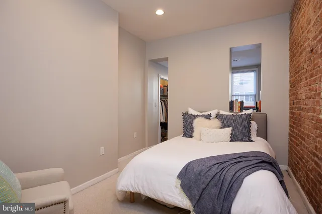 a bedroom with a bed and a lamp