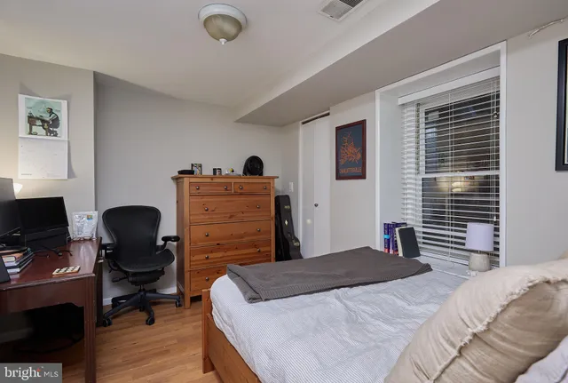 a bedroom that has a bed and a chair in it