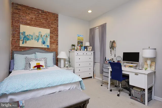 a bedroom with a workspace