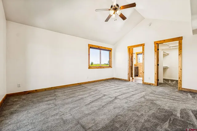 a view of a room with window and a ceiling fan