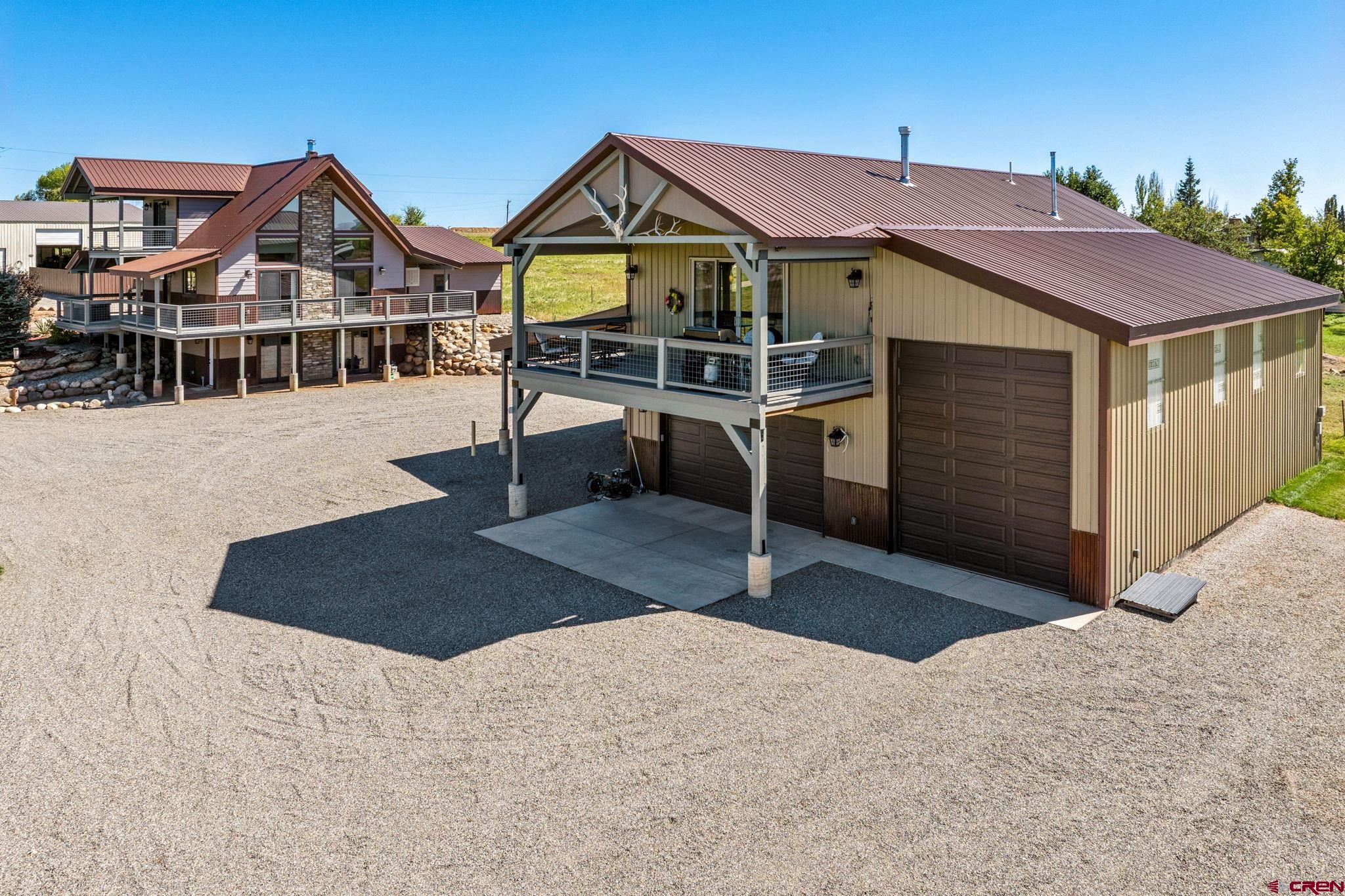 64 Summer Lane Durango, CO 81303 - Photo 2 of 25 a front view of a house with a yard and garage