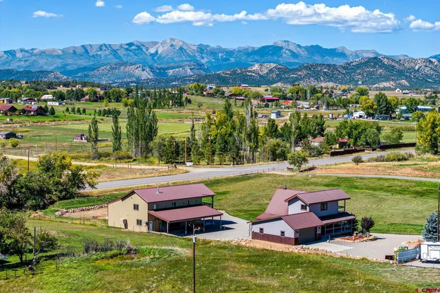 an aerial view of a house with garden space and outdoor seating