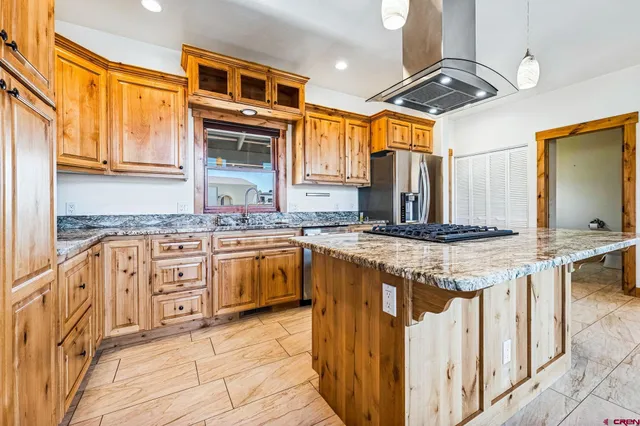 a kitchen with stainless steel appliances granite countertop a sink and cabinets