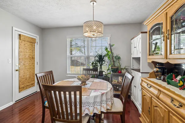 a kitchen with granite countertop a stove a sink and a microwave