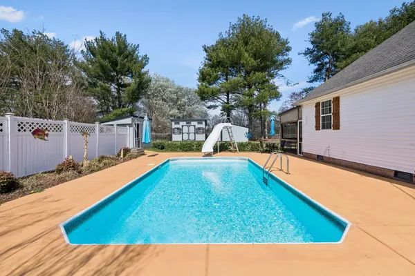a view of a house with a backyard