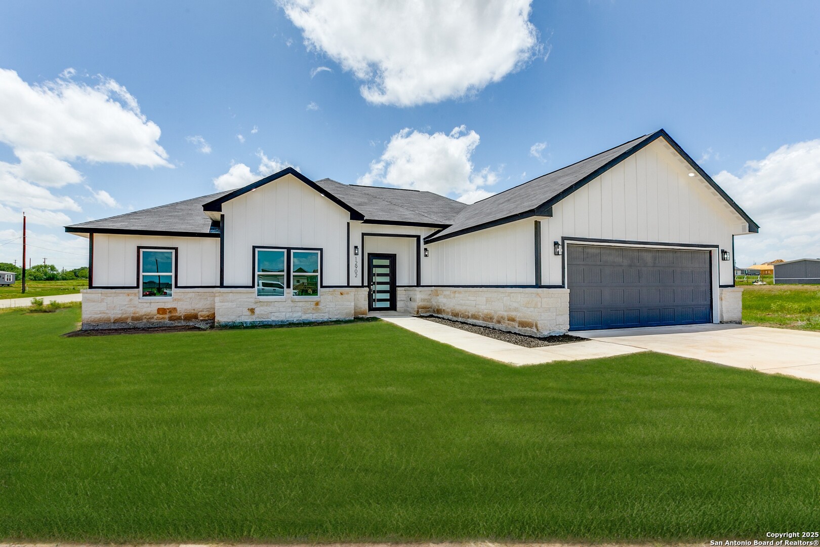 a front view of house with yard and green space
