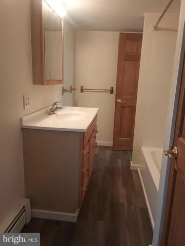 a bathroom with sink a mirror a bathtub and vanity