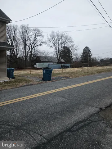 a view of a yard with large trees