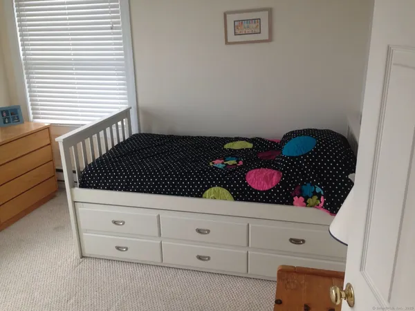 a bedroom with a bed and window