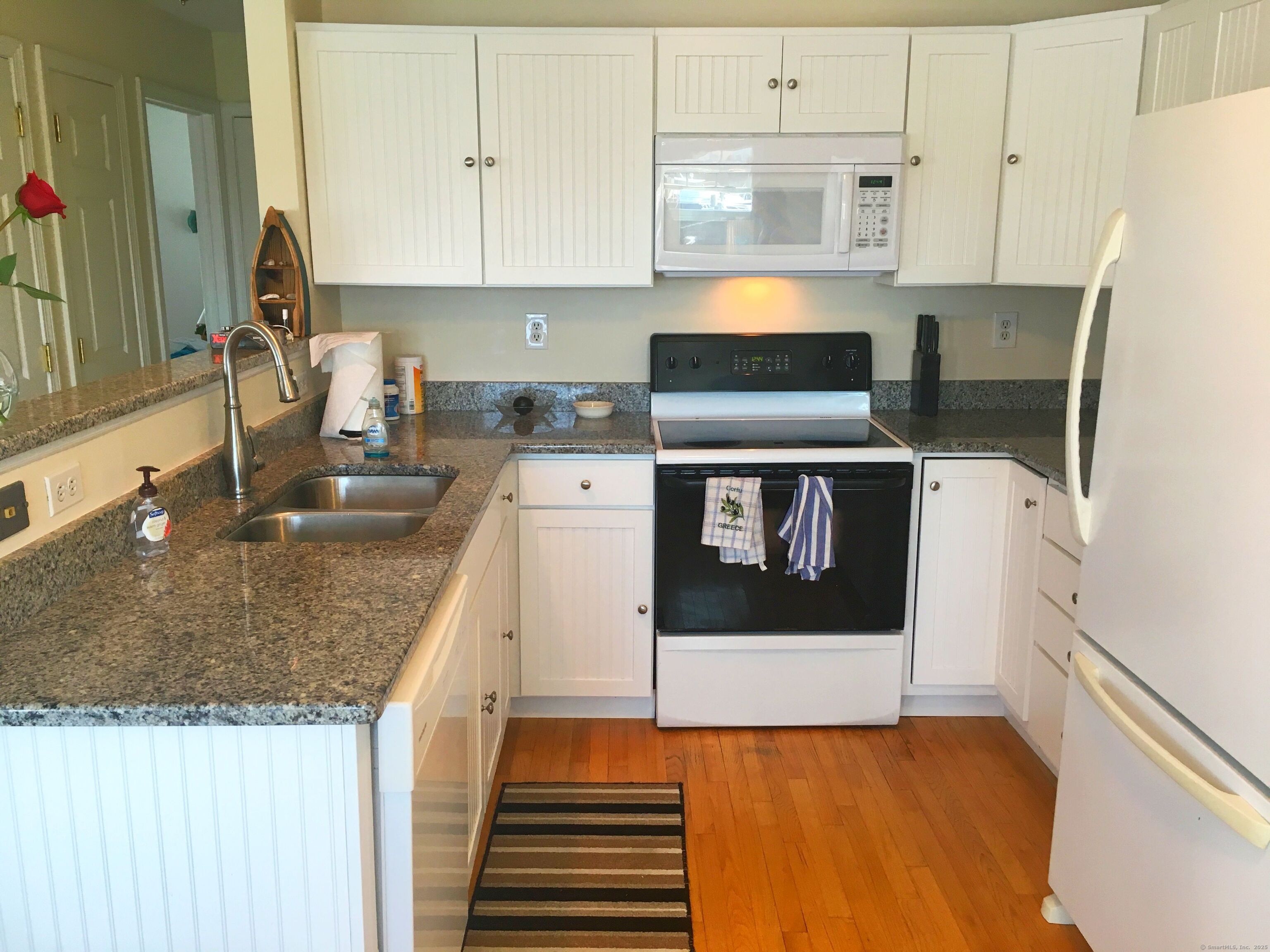 21 Atlantic Avenue Groton, CT 06340 - Photo 3 of 14 a kitchen with stainless steel appliances granite countertop a sink stove and white cabinets