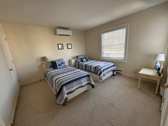 a bedroom with two beds and a couch