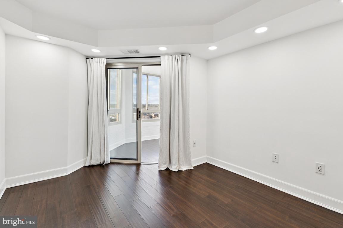 2151 Jamieson Avenue, Unit 1002 Alexandria, VA 22314 - Photo 15 of 25 a view of an empty room with wooden floor