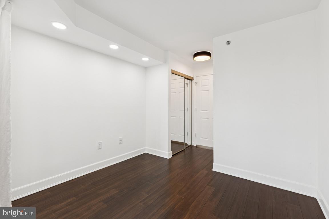 2151 Jamieson Avenue, Unit 1002 Alexandria, VA 22314 - Photo 16 of 25 an empty room with wooden floor and a window