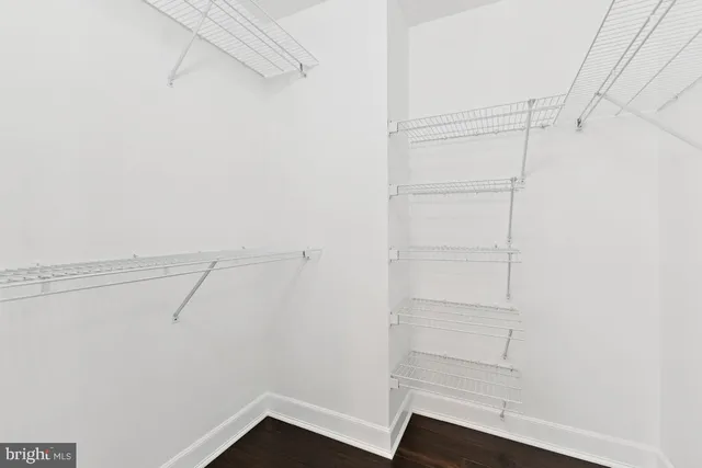 a view of walk in closet with empty racks