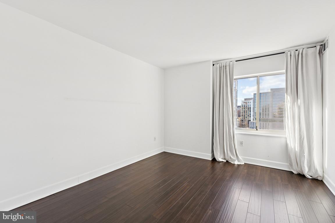 2151 Jamieson Avenue, Unit 1002 Alexandria, VA 22314 - Photo 19 of 25 an empty room with wooden floor and windows