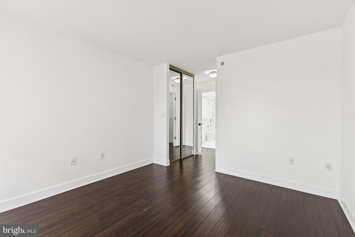 2151 Jamieson Avenue, Unit 1002 Alexandria, VA 22314 - Photo 20 of 25 a view of an empty room with wooden floor
