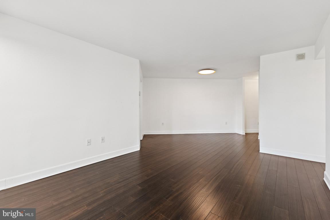 2151 Jamieson Avenue, Unit 1002 Alexandria, VA 22314 - Photo 6 of 25 an empty room with wooden floor and windows