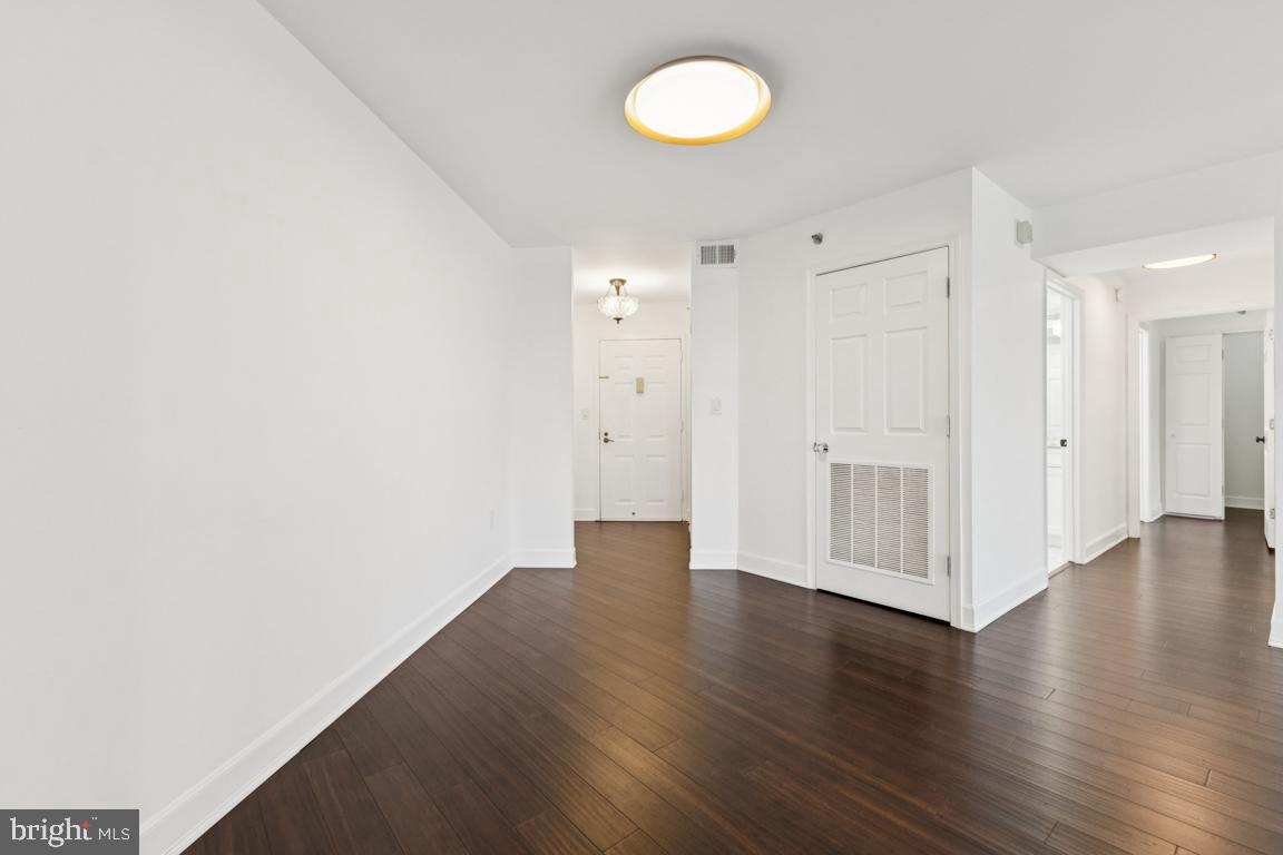 2151 Jamieson Avenue, Unit 1002 Alexandria, VA 22314 - Photo 8 of 25 a view of an empty room with wooden floor