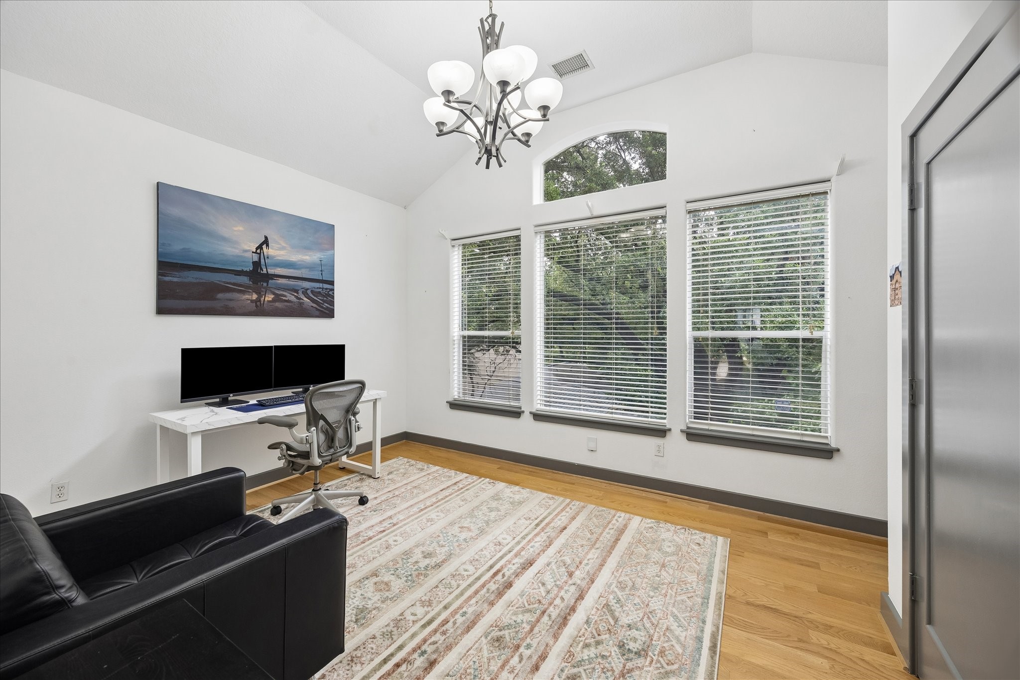 6406 Rodrigo Street, Unit B Houston, TX 77007 - Photo 22 of 27 .
Third floor guest bedroom with high ceilings, light fixture, large closet, wood flooring, and windows for natural light.