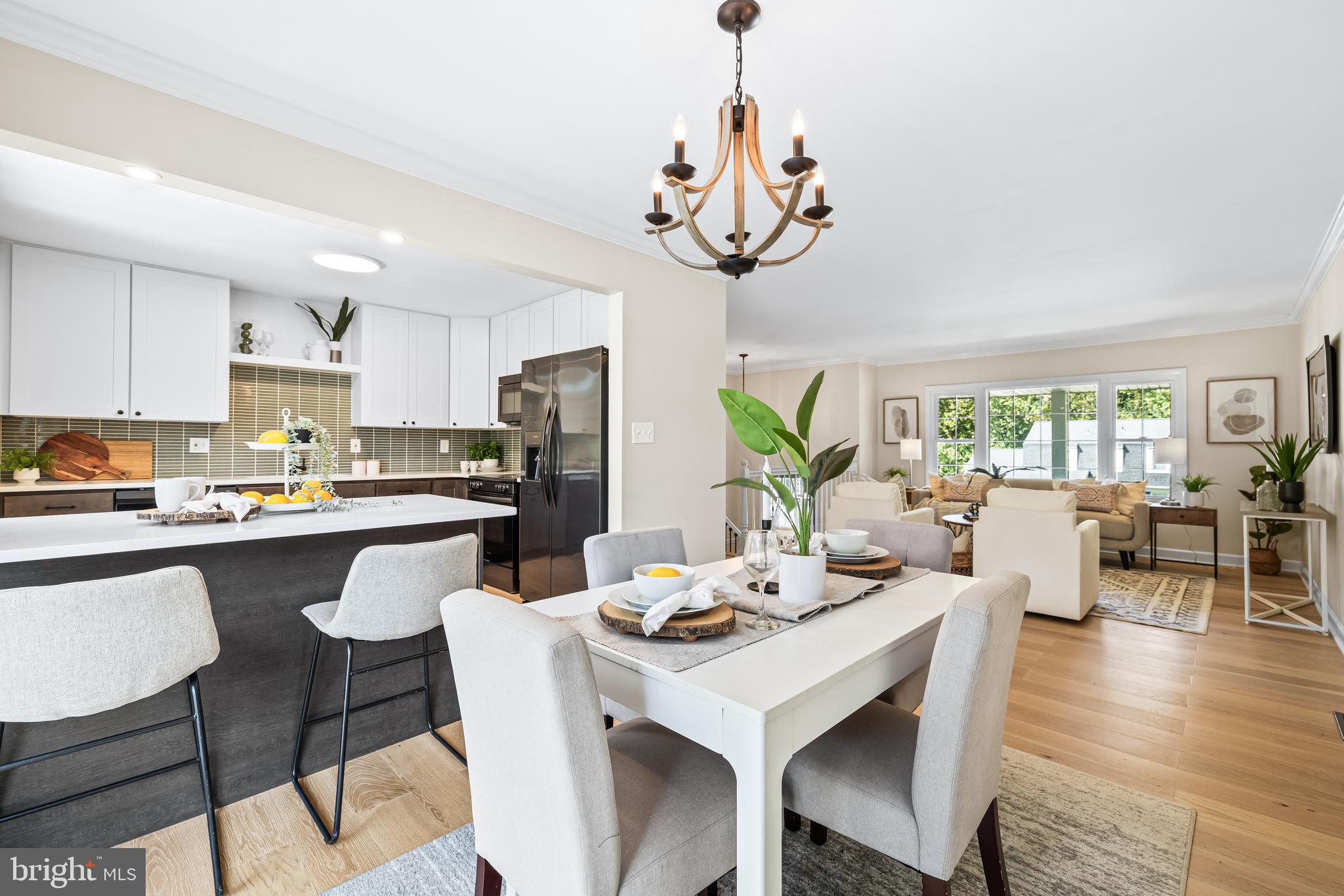 10845 Sandringham Road Cockeysville, MD 21030 - Photo 12 of 47 a view of a dining room and livingroom with furniture wooden floor a chandelier