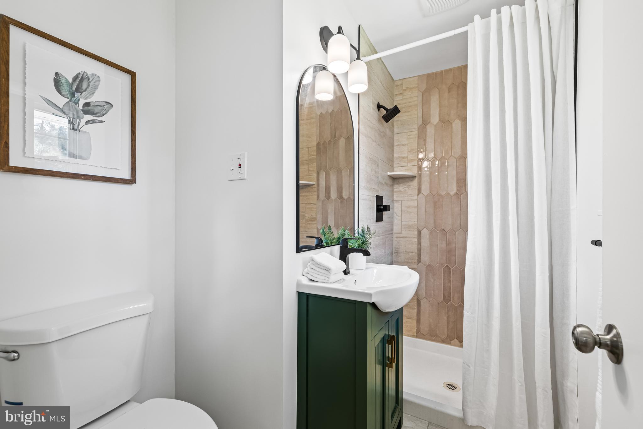 10845 Sandringham Road Cockeysville, MD 21030 - Photo 31 of 47 a bathroom with a sink mirror and toilet