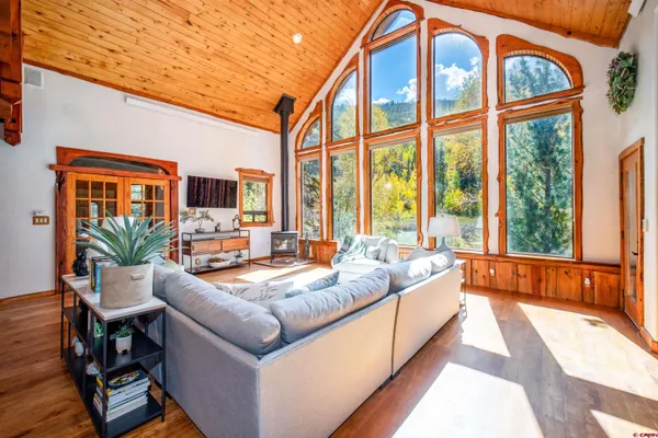 a large kitchen with lots of counter space and wooden floor